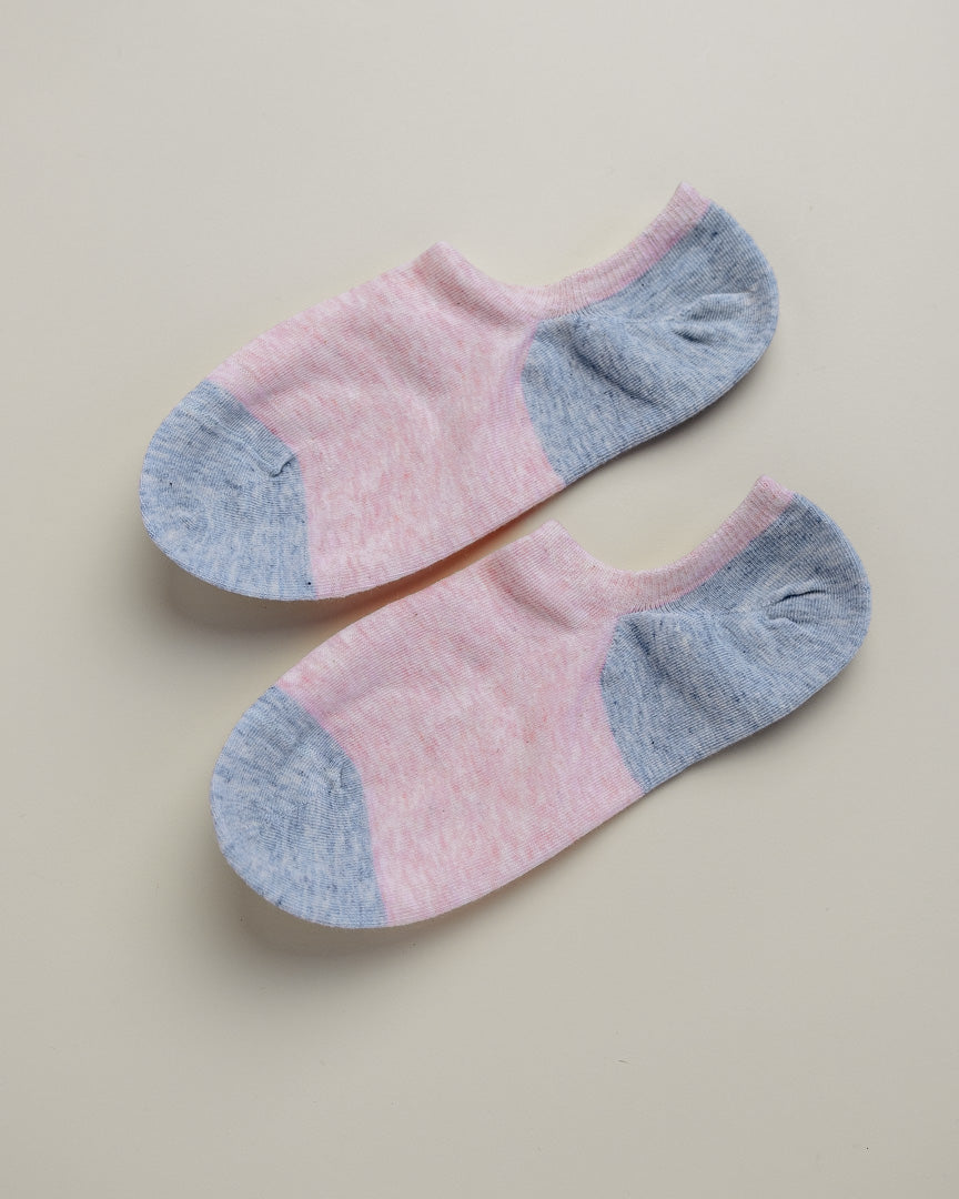 Pair of pink and gray ankle socks on a beige background