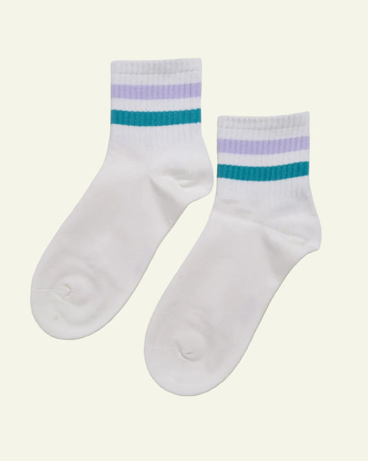 White socks with blue and purple stripes on a beige background