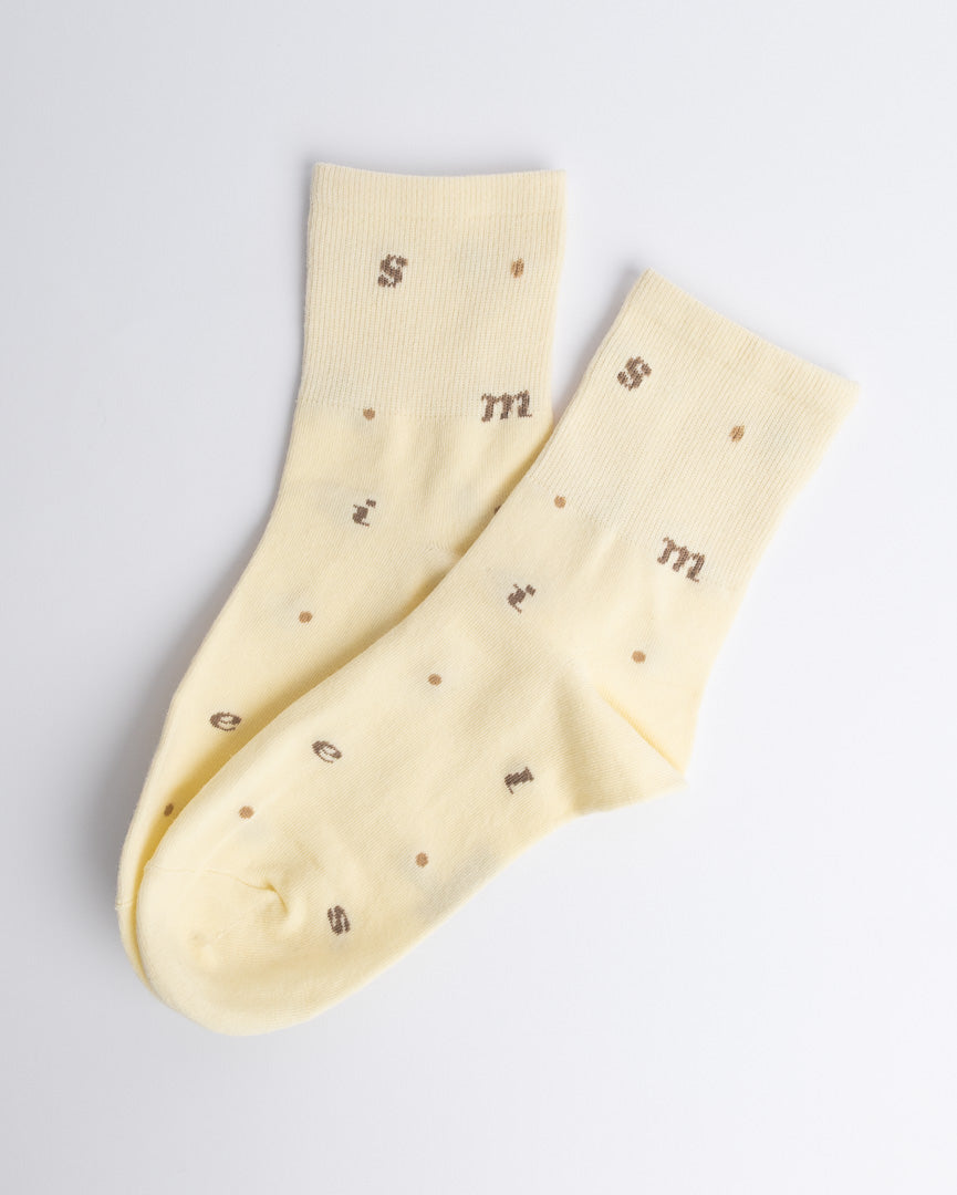 Butter yellow women’s cotton quarter socks with alphabet pattern