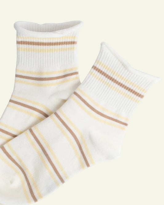 Pair of white socks with brown and yellow stripes on a light gray background