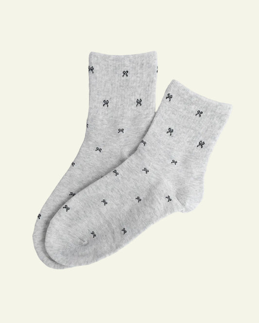 Gray socks with black patterns on a light gray background