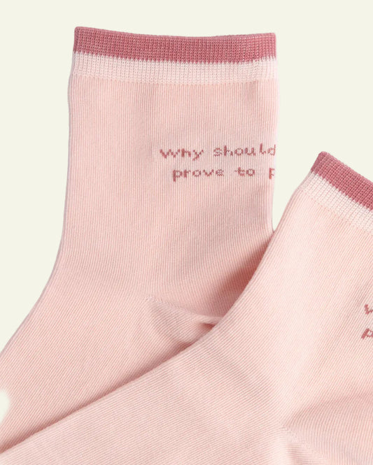 Pink socks with text on a light gray background