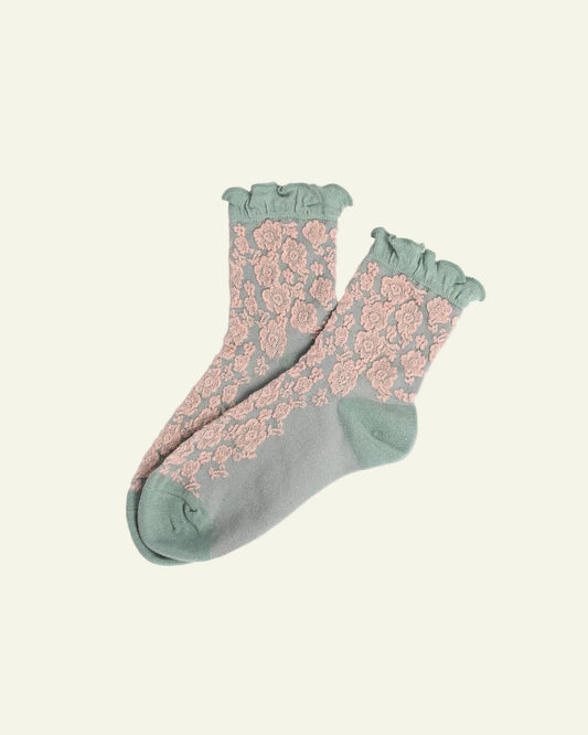 Pair of socks with floral pattern on a light gray background