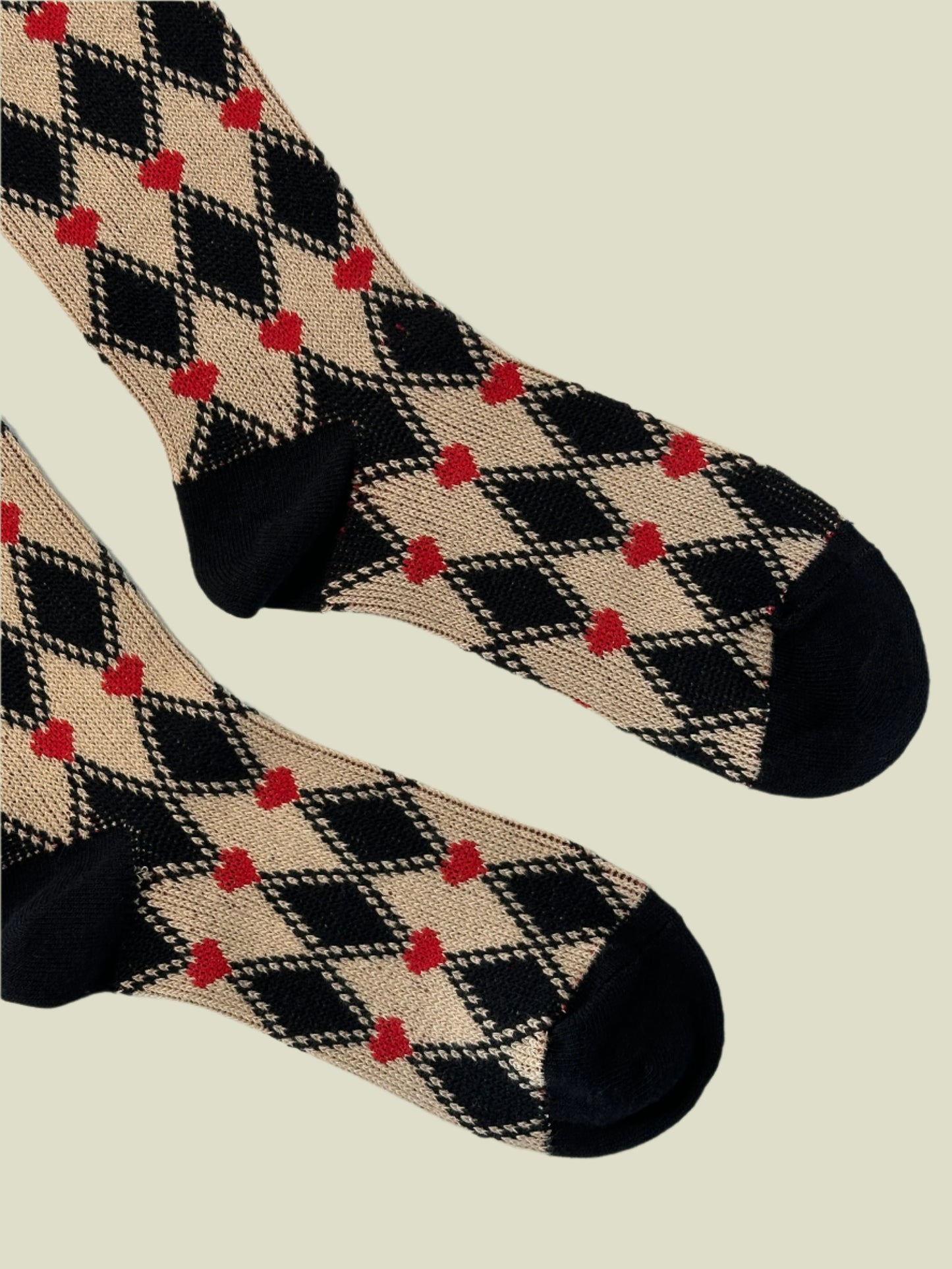 Plaid patterned socks with black and red design on a white background