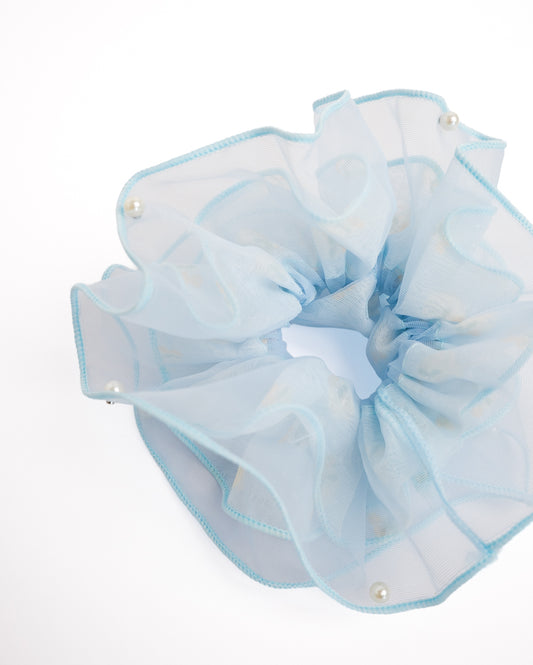 Close-up of light blue double-layer organza scrunchie featuring stud-clipped pearl accents and yellow cherry pattern