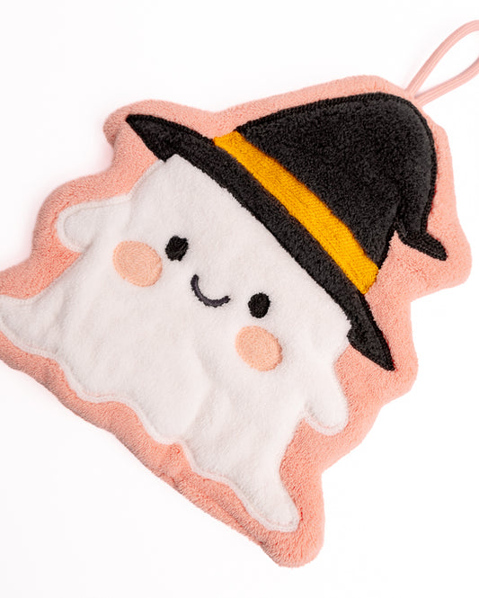 Close-up of pink witch ghost hanging hand towel showing soft coral fleece texture, embroidered face, and black witch hat details