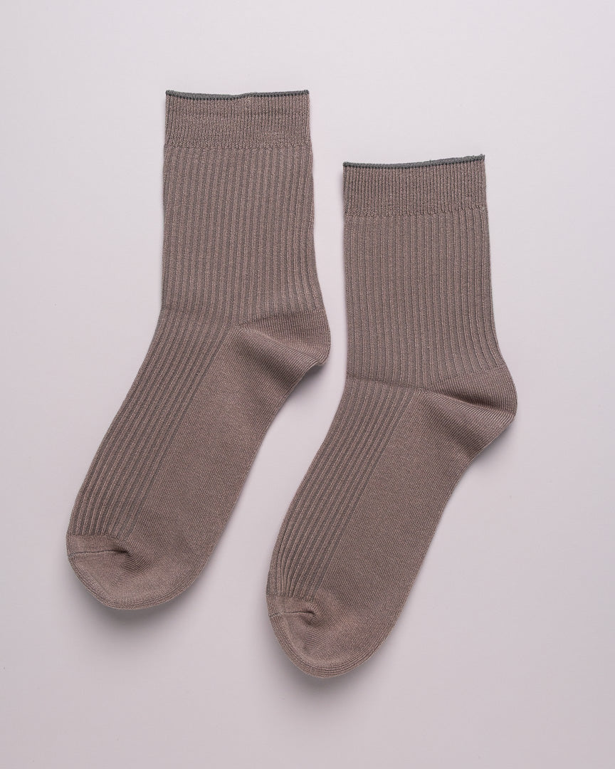 Pair of brown socks on a light gray background