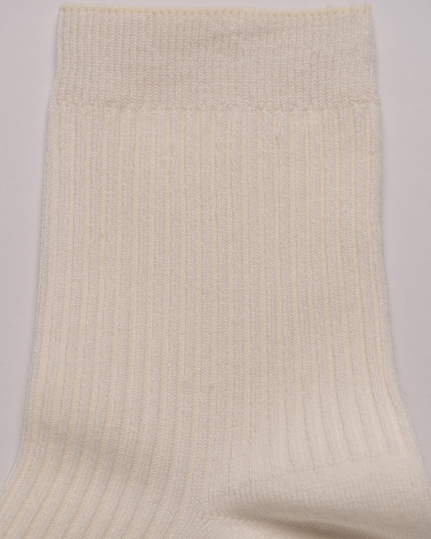 Beige ribbed sock on a light gray background