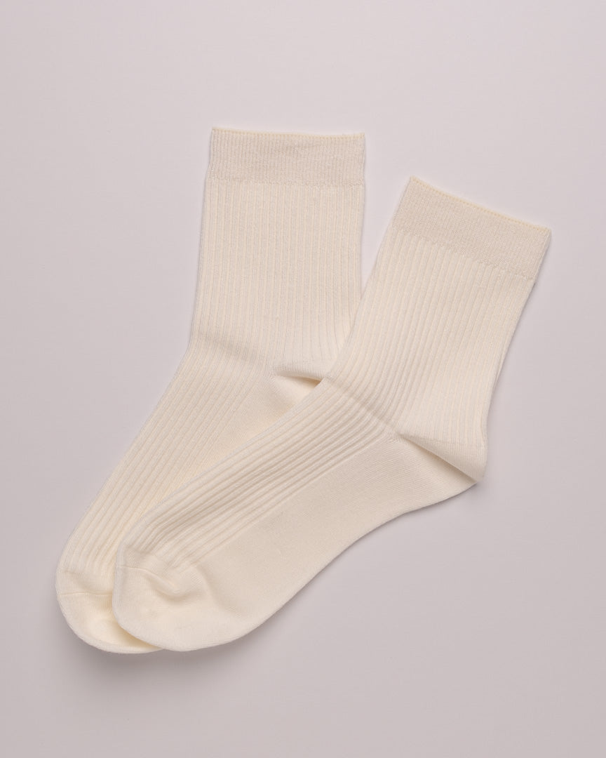 Pair of cream-colored socks on a light gray background