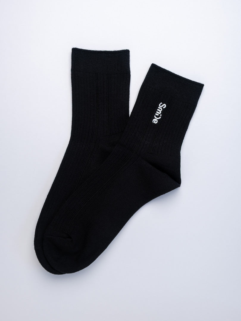 Black socks with a brand logo on a white background
