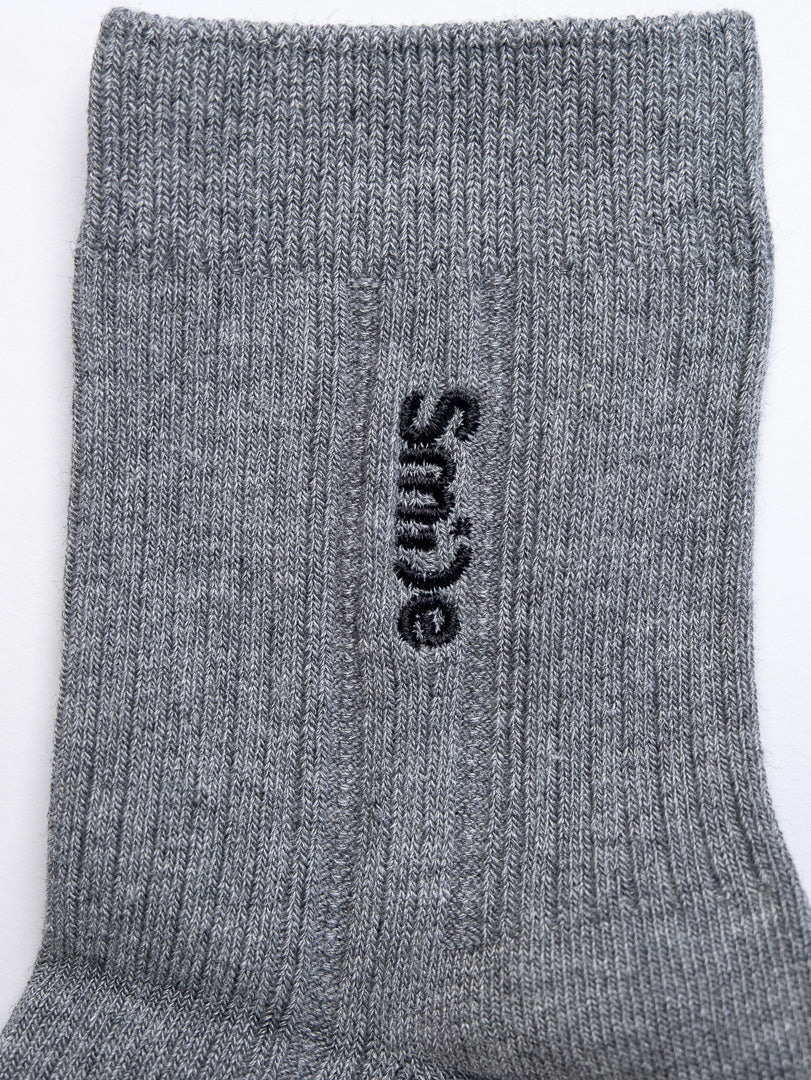 Gray sock with 'Smile' text on a white background