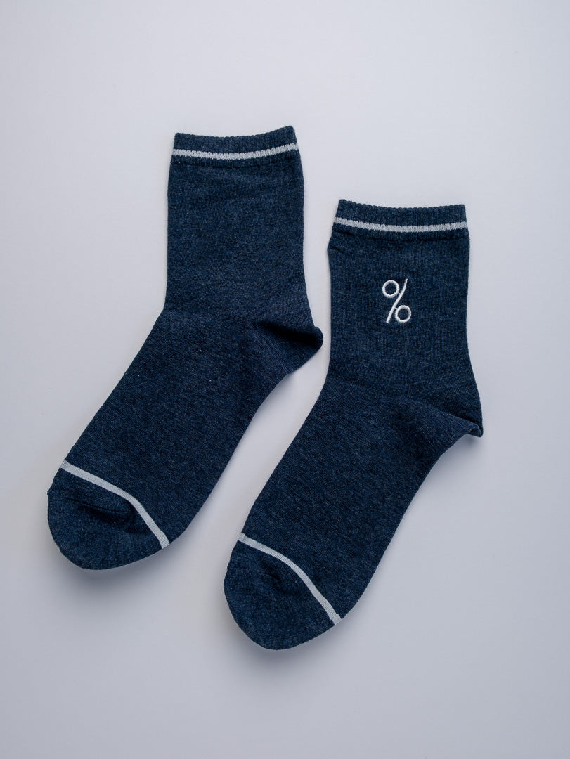 Pair of dark blue socks with white trim on a light gray background