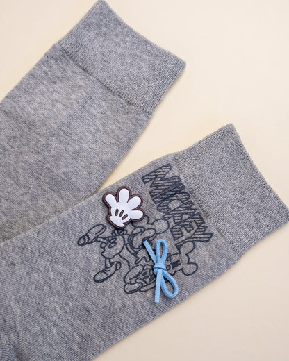 Gray socks with a cartoon character design on a beige background