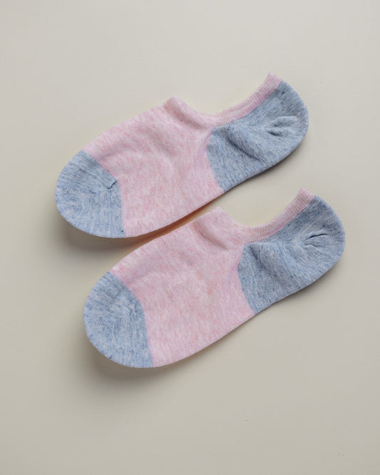 Pair of pink and gray ankle socks on a beige background