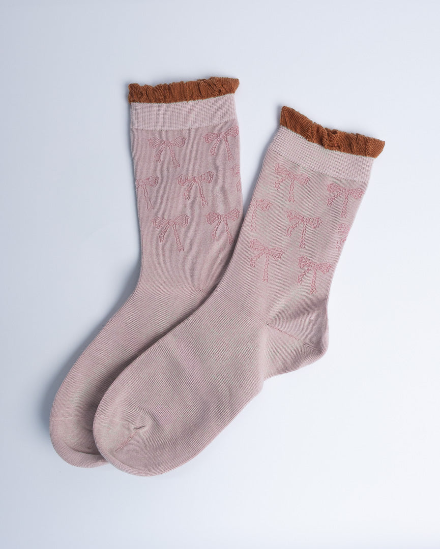 pink ruffle knit crew socks displayed on a white background