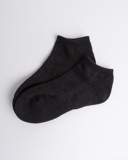 soft dark grey cotton ankle socks laid flat on a white backdrop