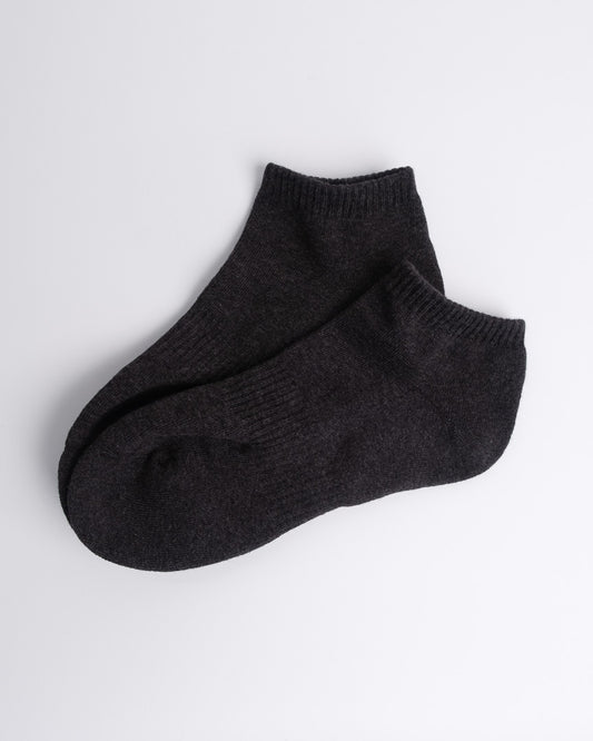 soft dark grey cotton ankle socks laid flat on a white backdrop