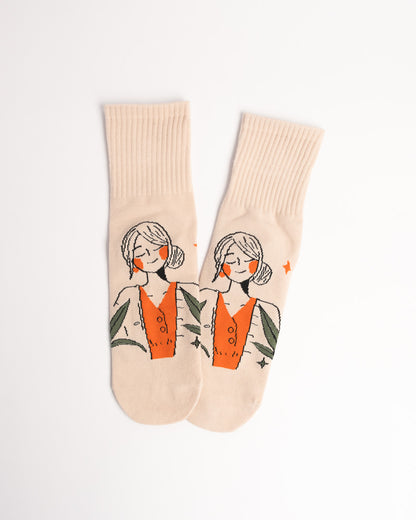 Beige socks with a graphic of a woman in a dress on a white background