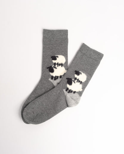 A pair of heather gray crew socks with a black and white sheep pattern on the sides, displayed on a clean white background.