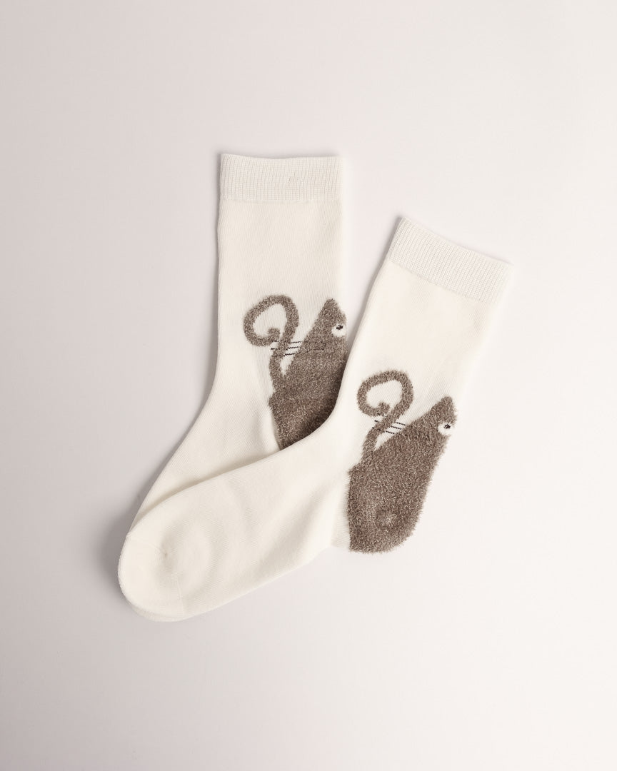 Women’s white cotton crew socks with a fuzzy brown curly-tail cat design