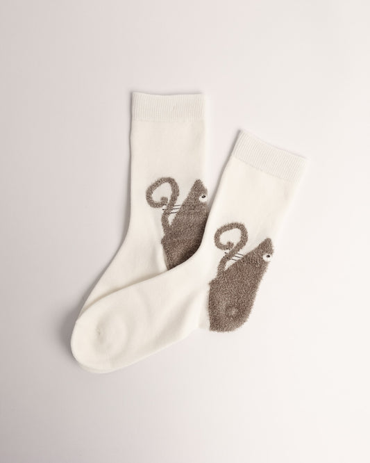 Women’s white cotton crew socks with a fuzzy brown curly-tail cat design