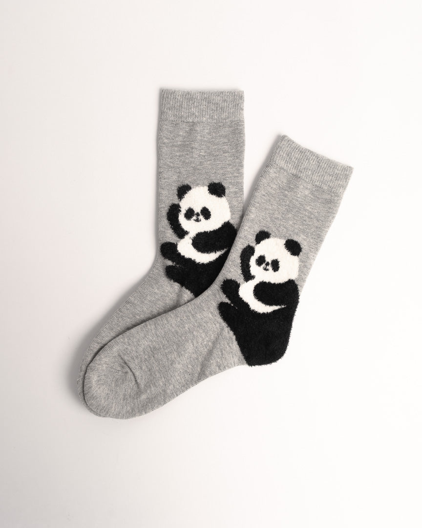 A pair of heather gray crew socks featuring a black and white knit panda design on the lower leg, displayed on a clean white background.