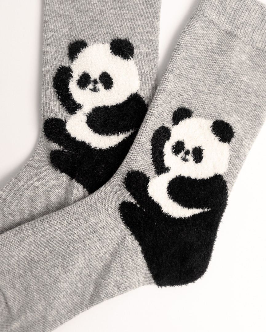 A pair of heather gray socks featuring a large black and white panda design on the front, photographed against a clean white background.
