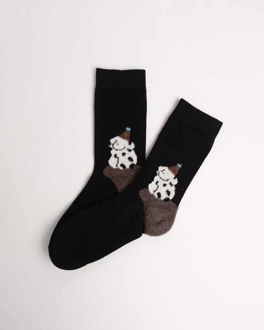 Black cotton crew socks featuring a fuzzy spotted dog wearing a party hat