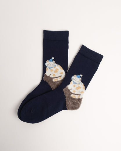 Navy cotton crew socks featuring a fuzzy spotted cat wearing a blue nightcap