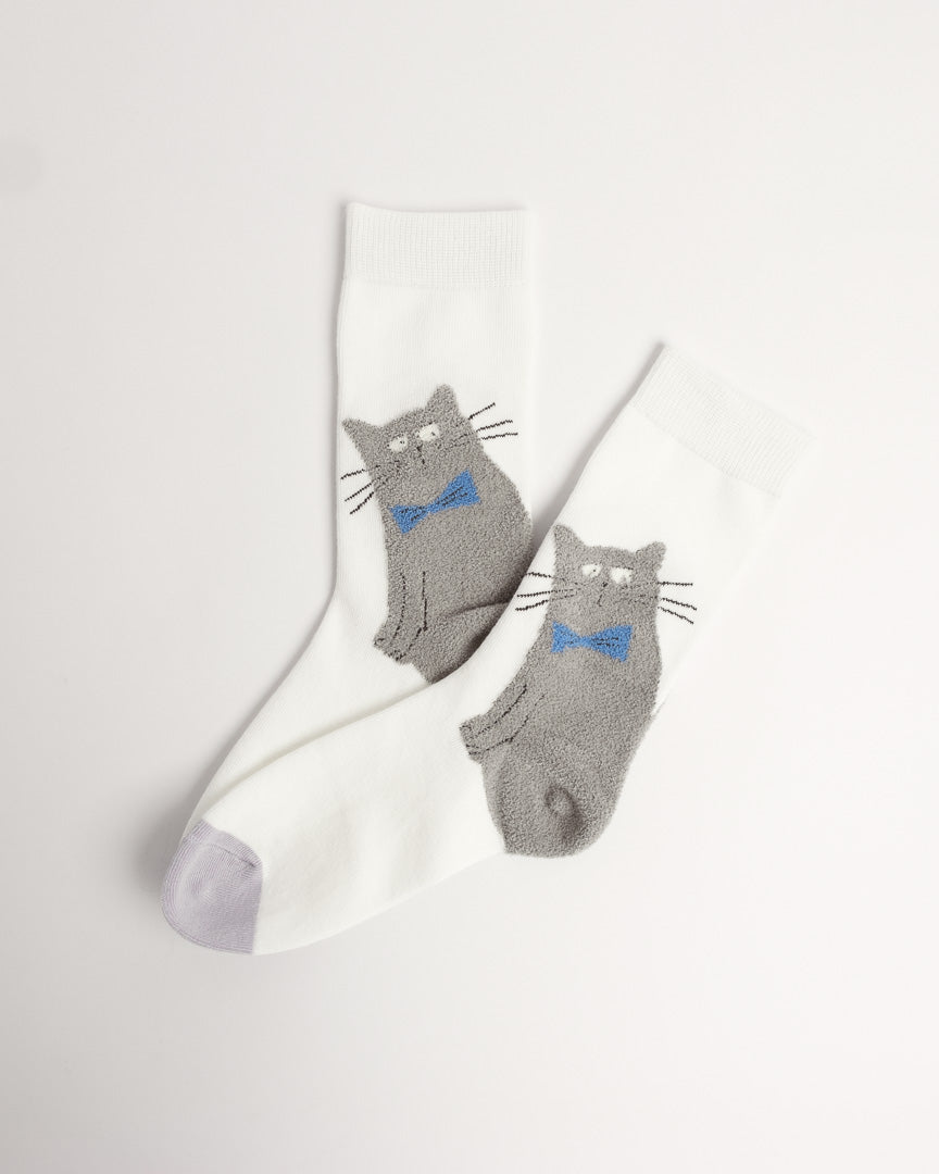 A pair of white crew socks with gray cat graphics wearing blue bow ties, displayed on a clean off-white background.