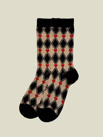 Plaid socks with red hearts on a light gray background