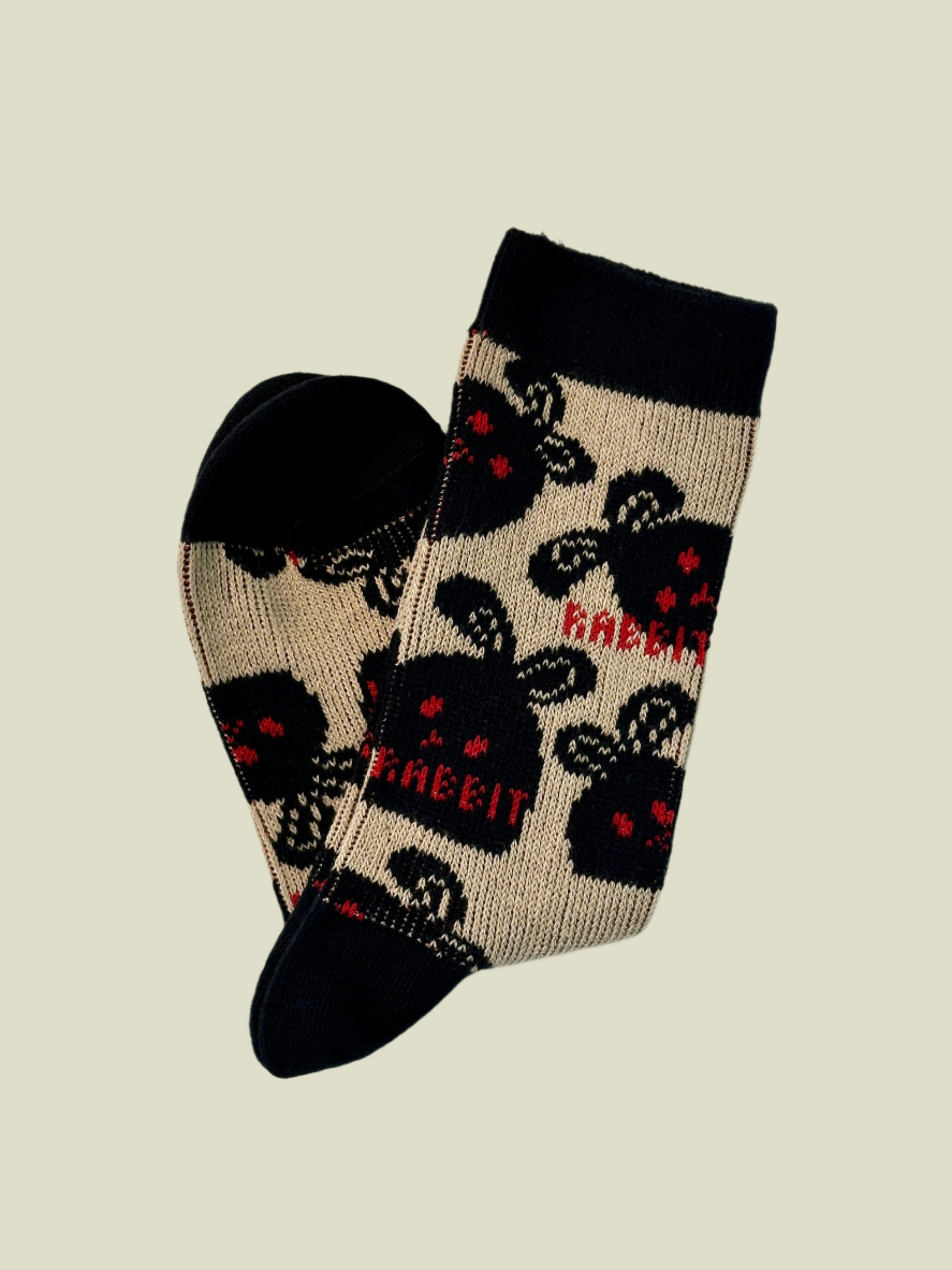 Pair of socks with black cat design on a light gray background