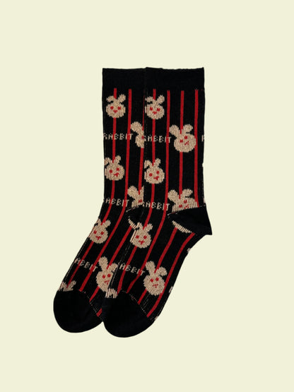 Pair of socks with skull and crossbones design on a light gray background