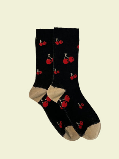 Black socks with red and white designs on a light gray background