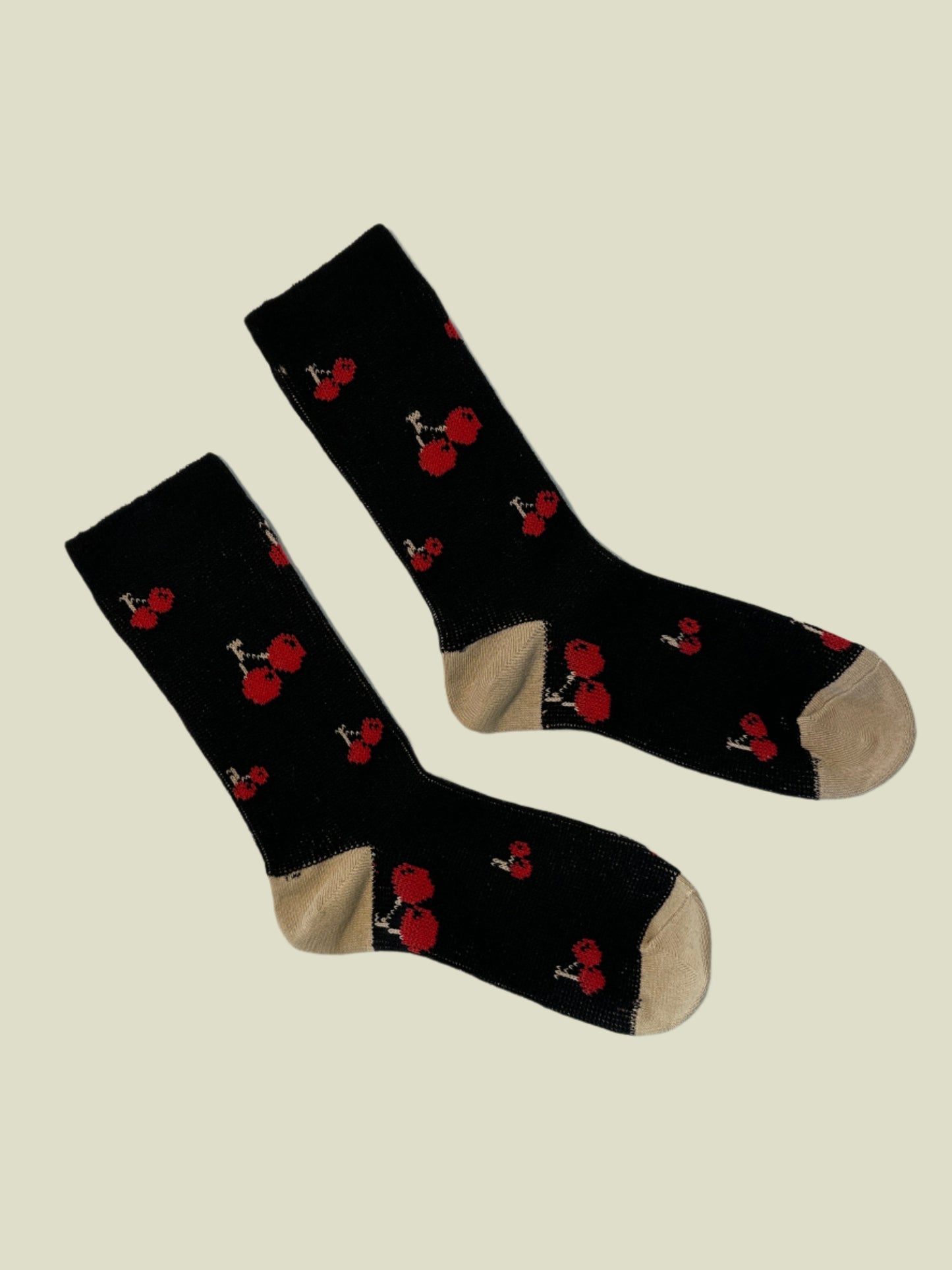 Black socks with red flower patterns on a white background