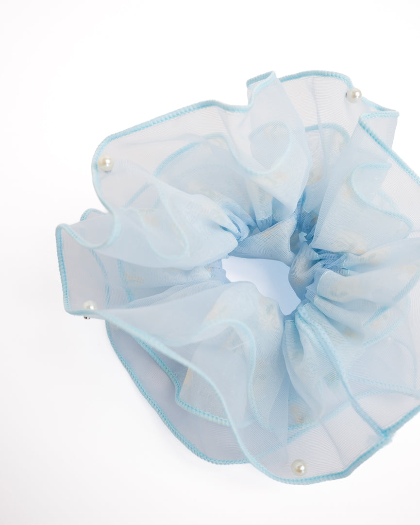 Close-up of light blue double-layer organza scrunchie featuring stud-clipped pearl accents and yellow cherry pattern
