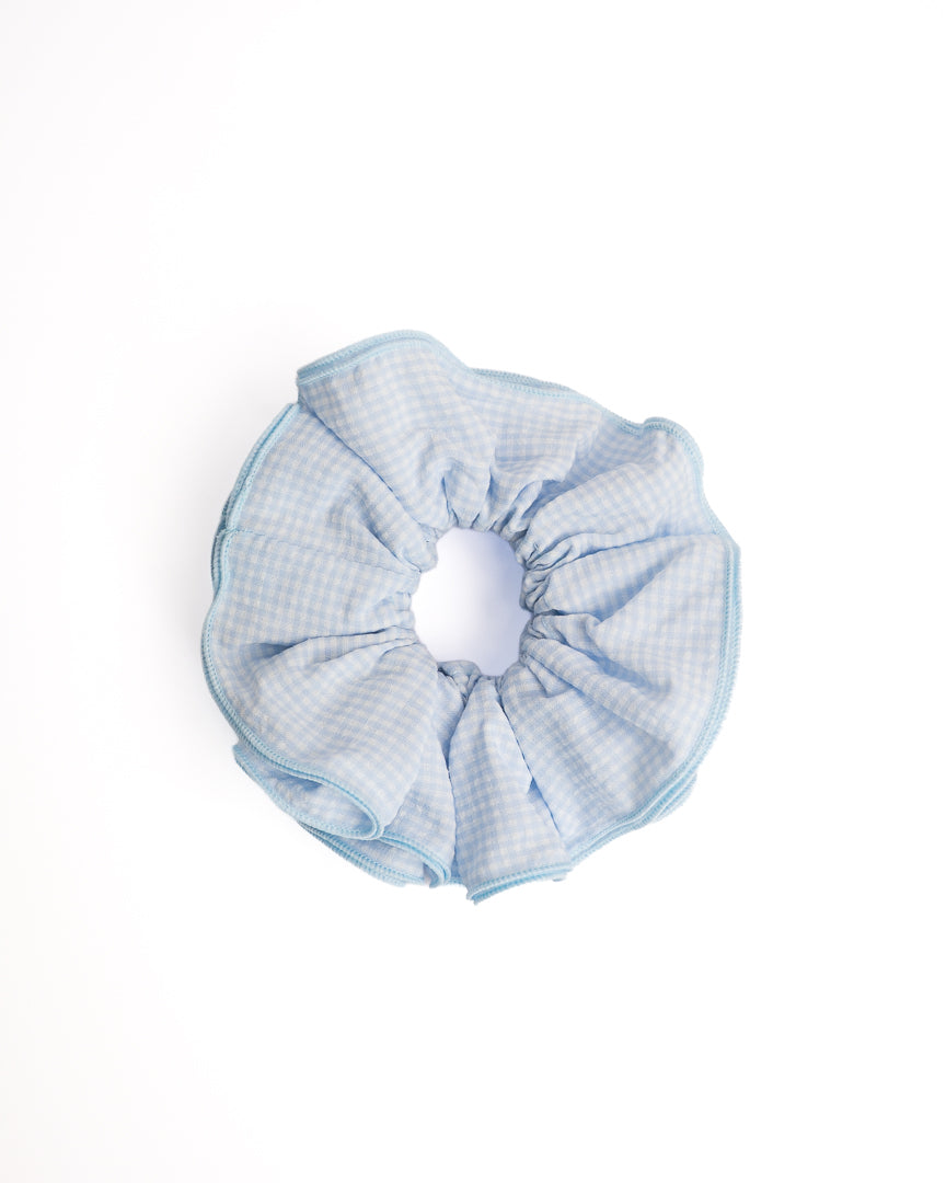 Gingham Blue Trim Hair Scrunchie in light blue with matching blue piping on flat lay white background