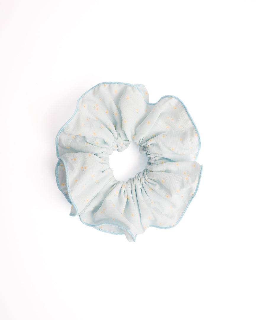 Sweet Daisy Scalloped Sheer XL Scrunchie in light blue featuring mini daisy print and scalloped crochet edge on flat lay white background