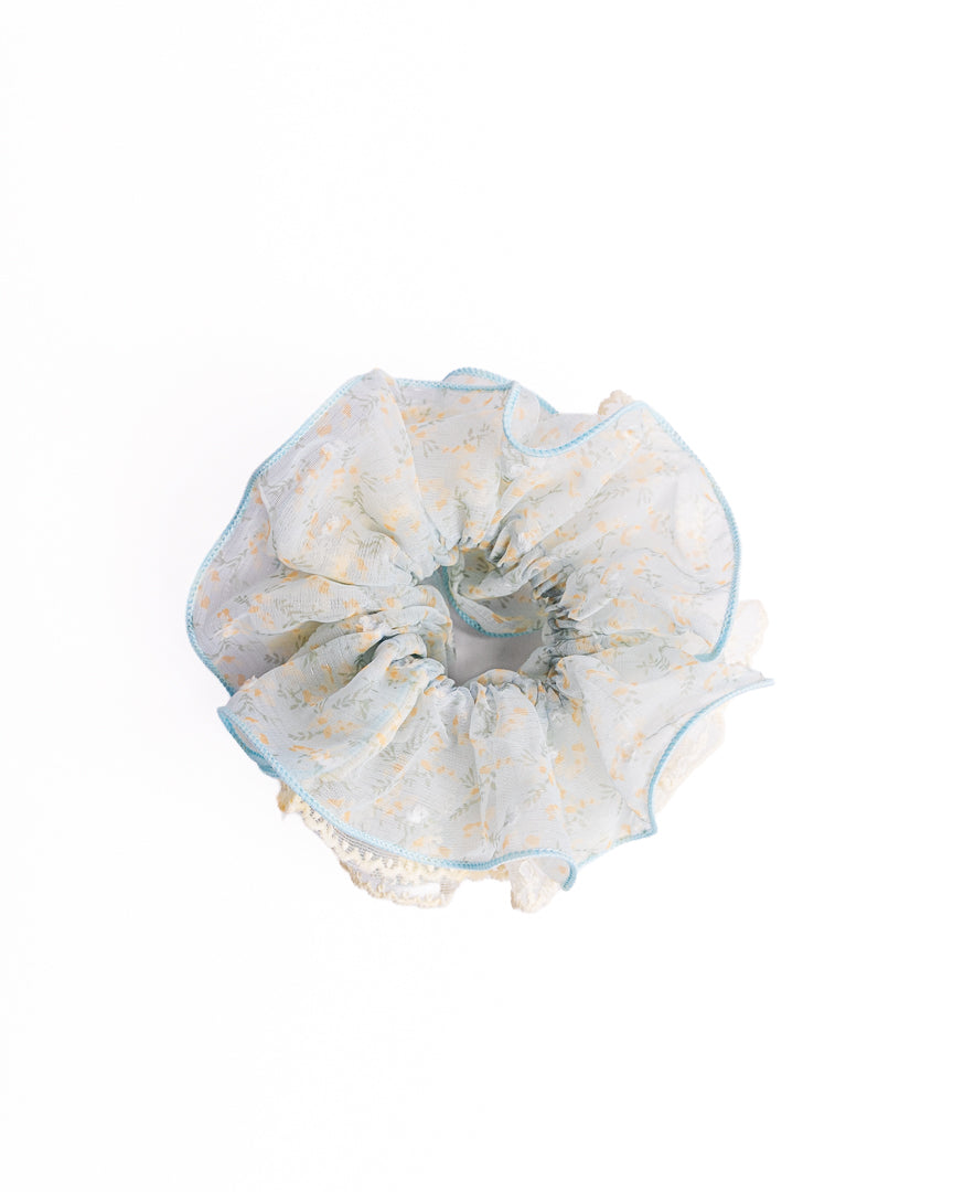 Scalloped Yellow Floral Sheer Hair Scrunchie in light blue featuring yellow floral print and embroidered lace trim on flat lay white background