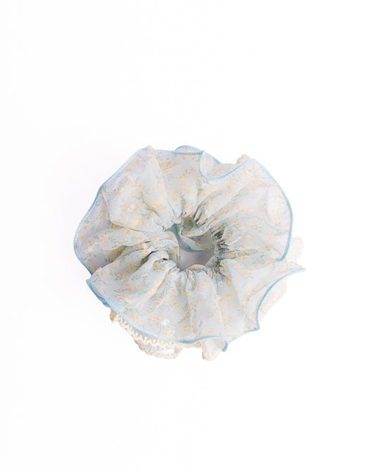 Scalloped Yellow Floral Sheer Hair Scrunchie in light blue featuring yellow floral print and embroidered lace trim on flat lay white background