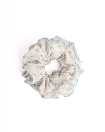 Blue Trim Floral Sheer Hair Scrunchie in cream featuring blue floral print and light blue trim on flat lay white background