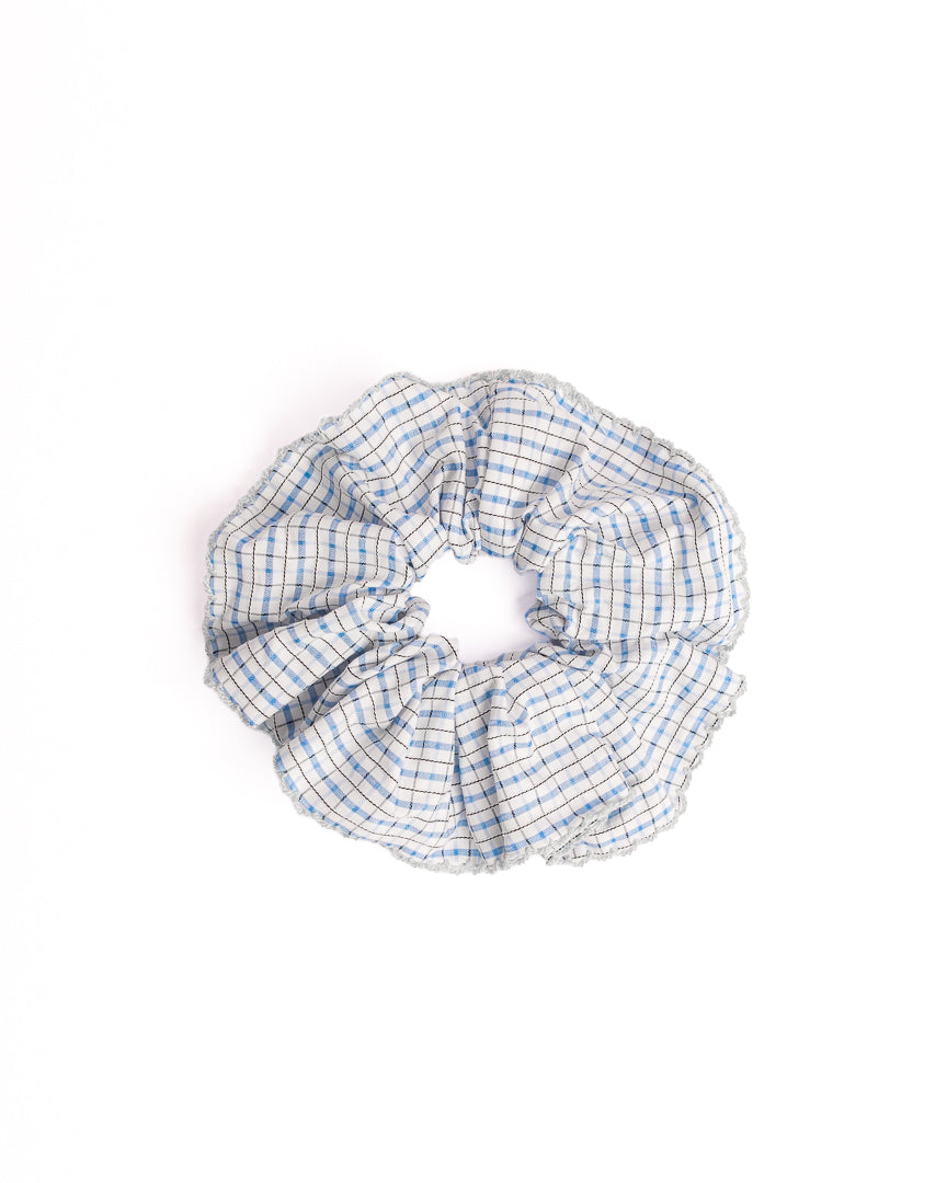 Handcrafted Blue Gingham Trim Hair Scrunchie in blue featuring blue and white check pattern and light blue trim on flat lay white background