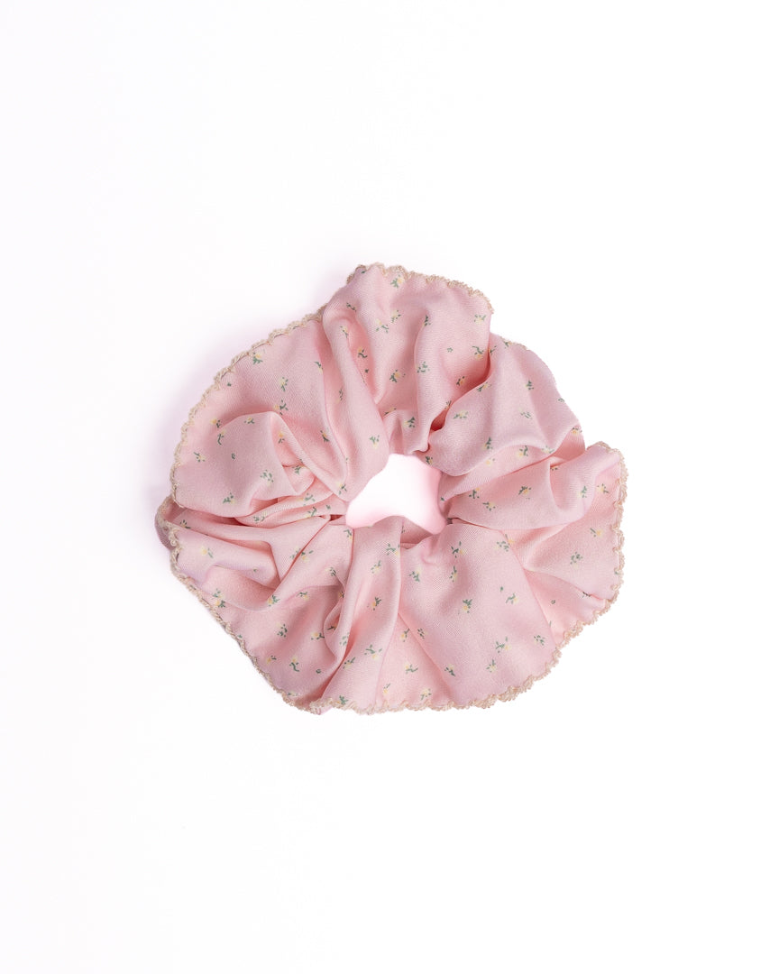Ditsy Floral Scalloped Silky Hair Scrunchie in pink featuring mini floral print and scalloped crochet edge on flat lay white background