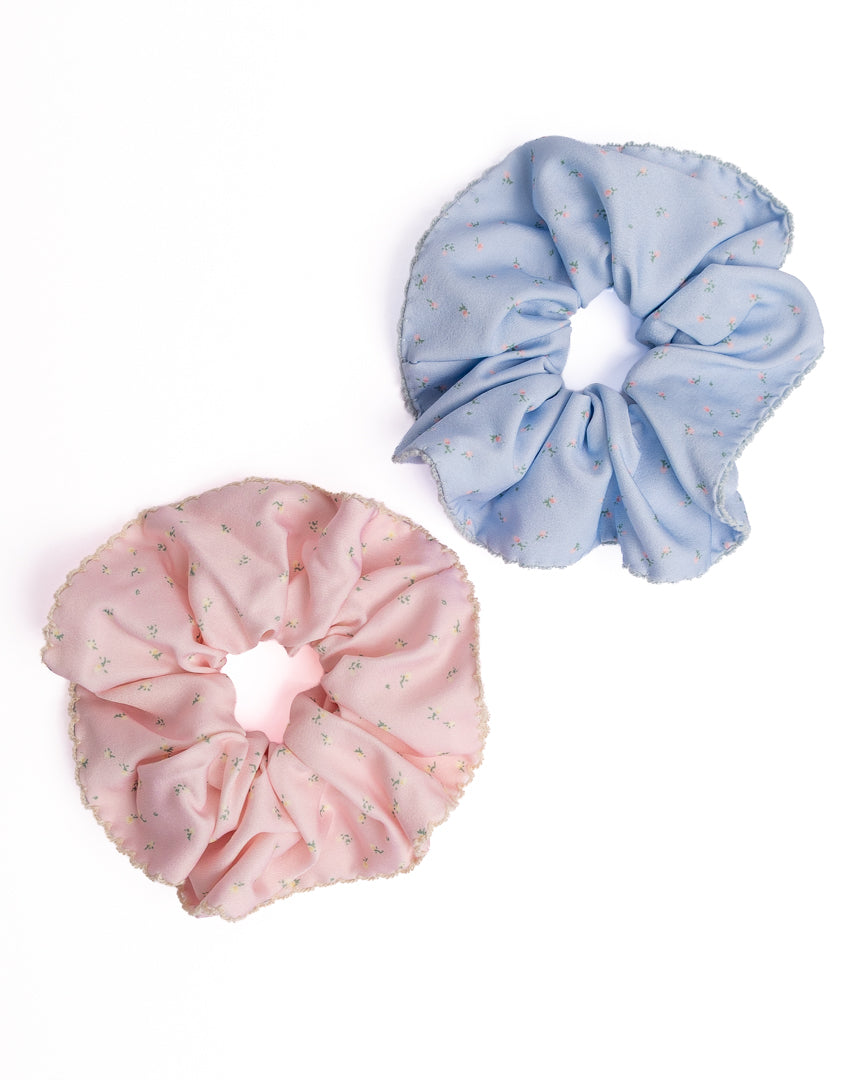 Ditsy Floral Scalloped Silky Hair Scrunchies in pink and light blue pastel colors on flat lay white background