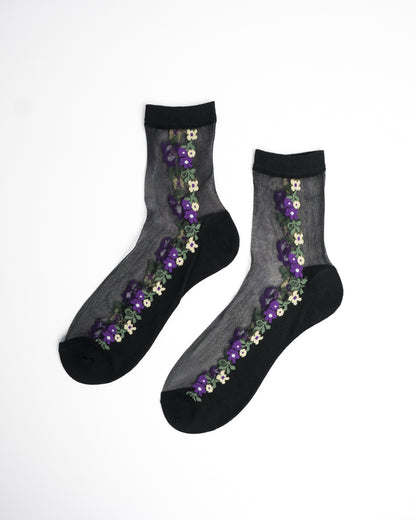 Midnight Violet Sheer Crew Socks in black with purple and yellow floral embroidery on flat lay white background