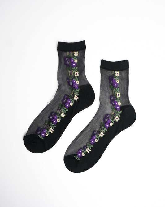 Midnight Violet Sheer Crew Socks in black with purple and yellow floral embroidery on flat lay white background