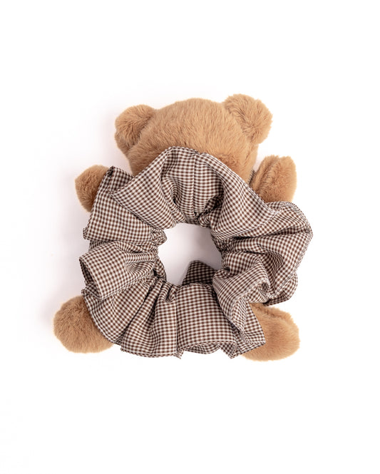 Top view of fluffy brown teddy bear hair scrunchie with gingham pattern highlighting voluminous ruffles