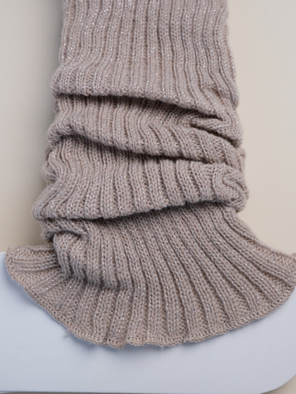 Knitted gray scarf on a light blue surface