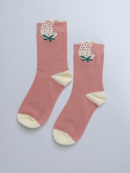 Pink socks with floral design on a light gray background