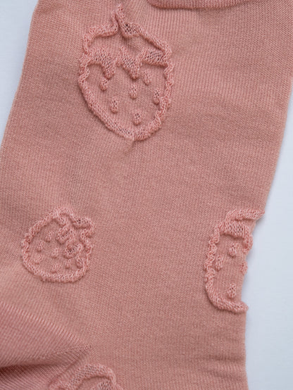 Pink fabric with embroidered designs on a light 